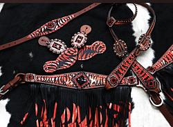 13865  5 piece headstall and breast collar set. This set features medium leather with a black and red striped design accented with copper studs and crystal rhinestones.